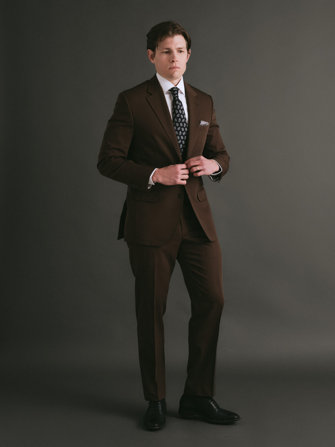 Full-length studio portrait in tailoring